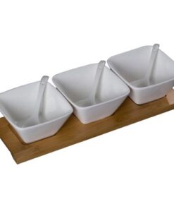 Porcelain bowl set with matching spoons on a real bamboo serving